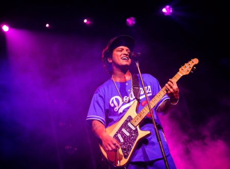 Bruno Mars belts out his hit songs from the “Moonshine Jungle Tour” in 2014.