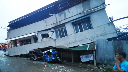 圖為居民昨天在南納卯省巴達達社看著遭6.9級地震震塌的房子。