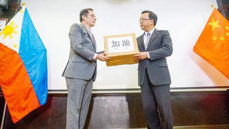 圖為菲副外長杜萊向中國駐菲大使黃溪連移交菲律濱捐贈的抗疫物資。（中國大使館提供）