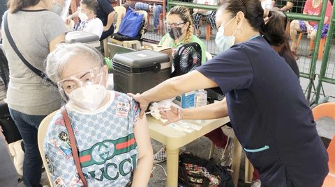 3月30日，一位長者在馬尼拉市政府安排的注射點處接種新冠疫苗。菲律濱自3月1日啟動全民免疫計劃。（中新社）