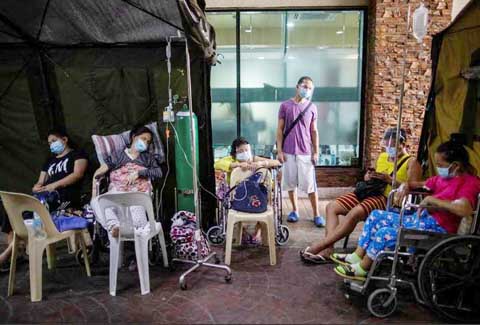 圖為國家腎臟和移植研究所的新冠肺炎病患昨日坐在輪椅上接受治療，該醫院已經爆滿，病患沒有床位，只能坐在輪椅上治療。