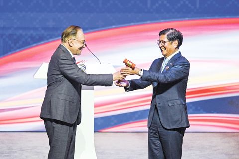 10月28日，在馬來西亞吉隆坡舉行的第47屆東盟峰會及系列會議閉幕式上，馬來西亞總理安瓦爾（左）將輪值主席國木槌移交給2026年東盟輪值主席國菲律濱總統馬科斯。第47屆東盟峰會及系列會議28日在馬來西亞首都吉隆坡閉幕。（新華社）