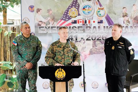4月14日,在計順市亞銀那洛軍營軍事總部舉行的即將到來的代號為「肩並肩」聯合軍事演習新聞發布會上,美國陸軍上校羅伯特·邦(中)與菲律濱海軍上校丹尼斯·赫爾南德斯(左)和加拿大海軍少校克雷格·庫克(右)一同發言。(美聯社)